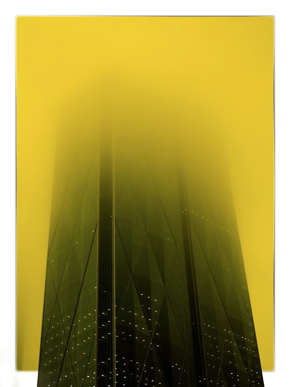 A glass tower with a diagonal grid facade rising into flat chrome yellow, the top half of the building dissolved completely into the colour while the lower half stays sharp enough to count the lit windows. A thin white edge shows along the top and left.